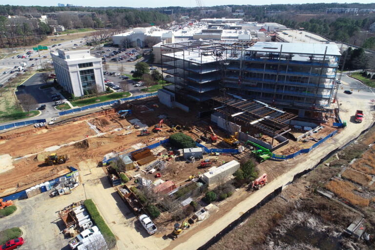 Aerial view of the Crabtree Terrace construction milestone with a multi-story building framework in an urban setting.