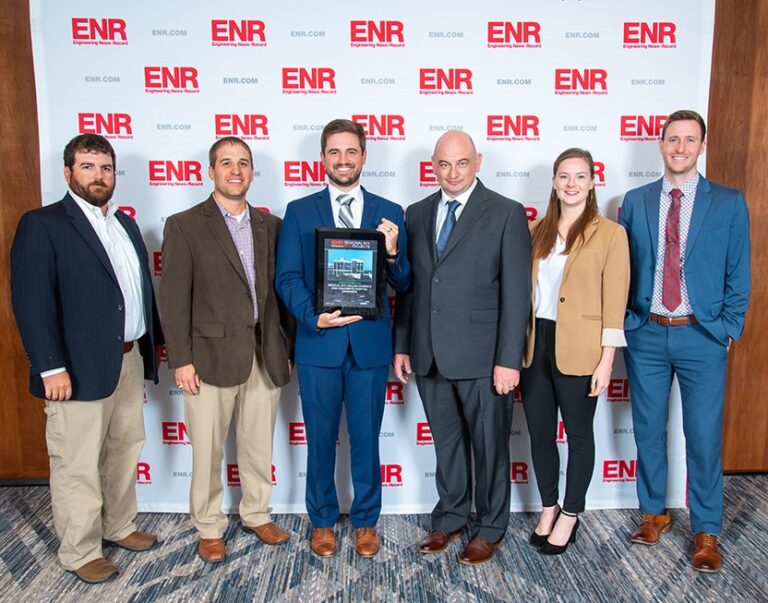Group of professionals posing with an ENR Southeast award at an event.