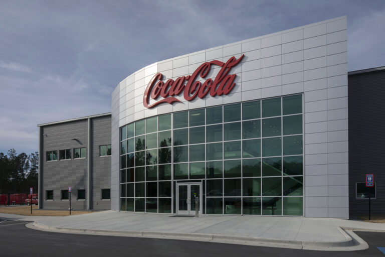 Modern Coca-Cola Bottling UNITED facility with large brand signage on the exterior, located at the South Metro Atlanta Sales Center.