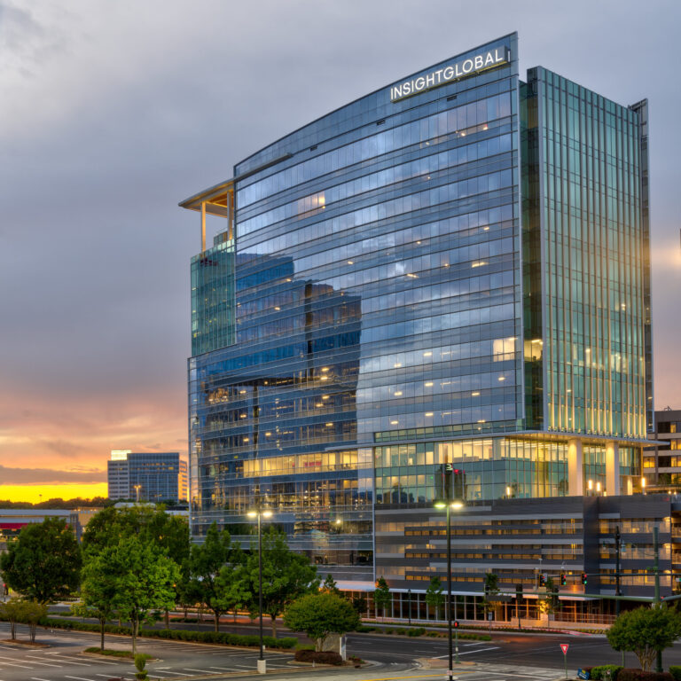 Modern glass office building at dusk with 