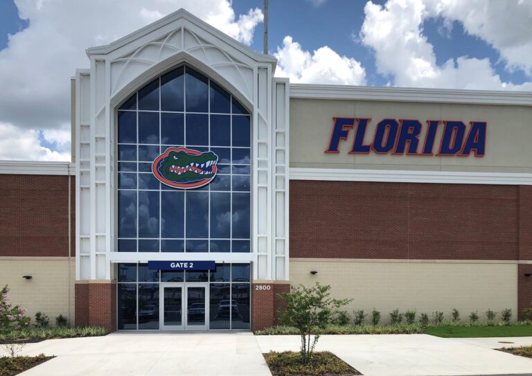 A modern building facade featuring a large 'florida' sign and the university of florida gators logo.