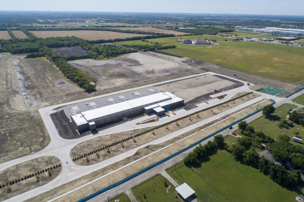 Aerial view of a new industrial building with surrounding undeveloped land, featured in ENR Southeast.