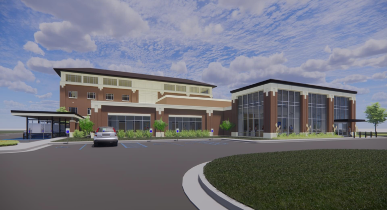 Artist's rendering of a modern two-story Health Clinic in Madison, Mississippi, with a glass facade and parking lot.