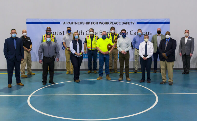 Group of individuals standing in a gymnasium for the OSHA Partnership event focused on workplace safety.