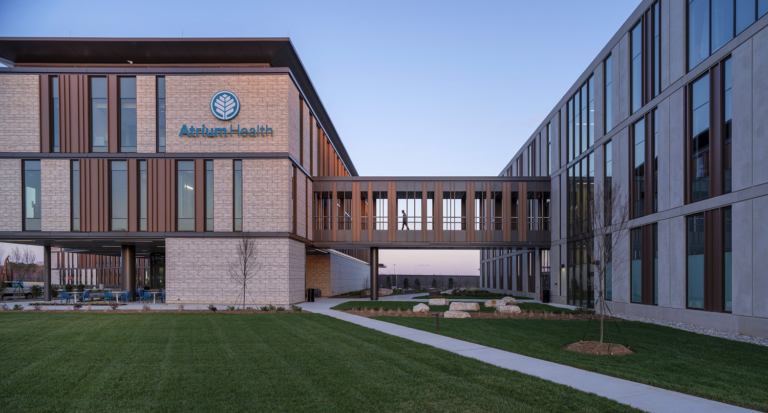 Modern medical facility with connecting skyway at twilight, part of the North Carolina Medical Office Building.