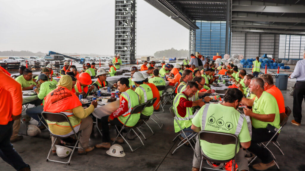 Construction workers taking a meal break at the Brasfield & Gorrie Project Titan worksite.