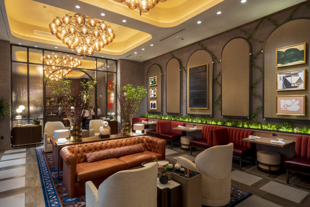 Elegant hotel lobby with plush seating, decorative lighting, and modern art pieces, honored by ENR for its four projects.