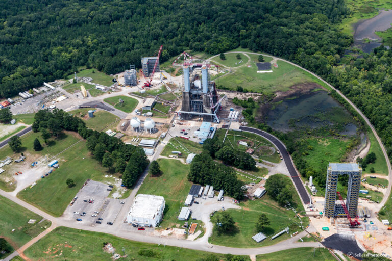 Aerial view of a space launch complex, showcasing Brasfield & Gorrie's role in space exploration infrastructure and vehicles under clear skies.