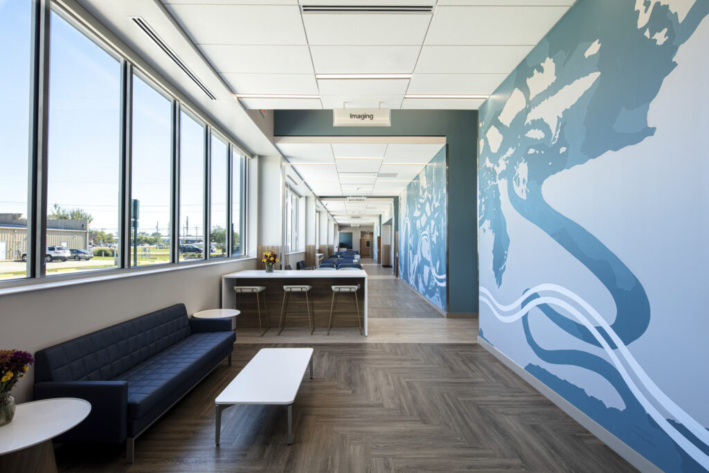 Modern medical office hallway with seating area, featuring a world map mural, showcases opportunities for developers in converted spaces.