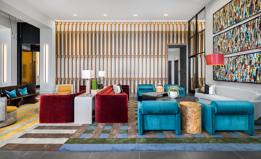 Modern hotel lobby in Midtown Union, Atlanta with colorful furniture and abstract art, opens.