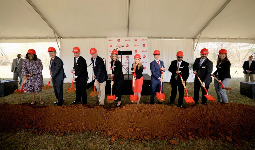 Group of individuals wearing hard hats and holding shovels at a groundbreaking ceremony for Brasfield & Gorrie's new facility.