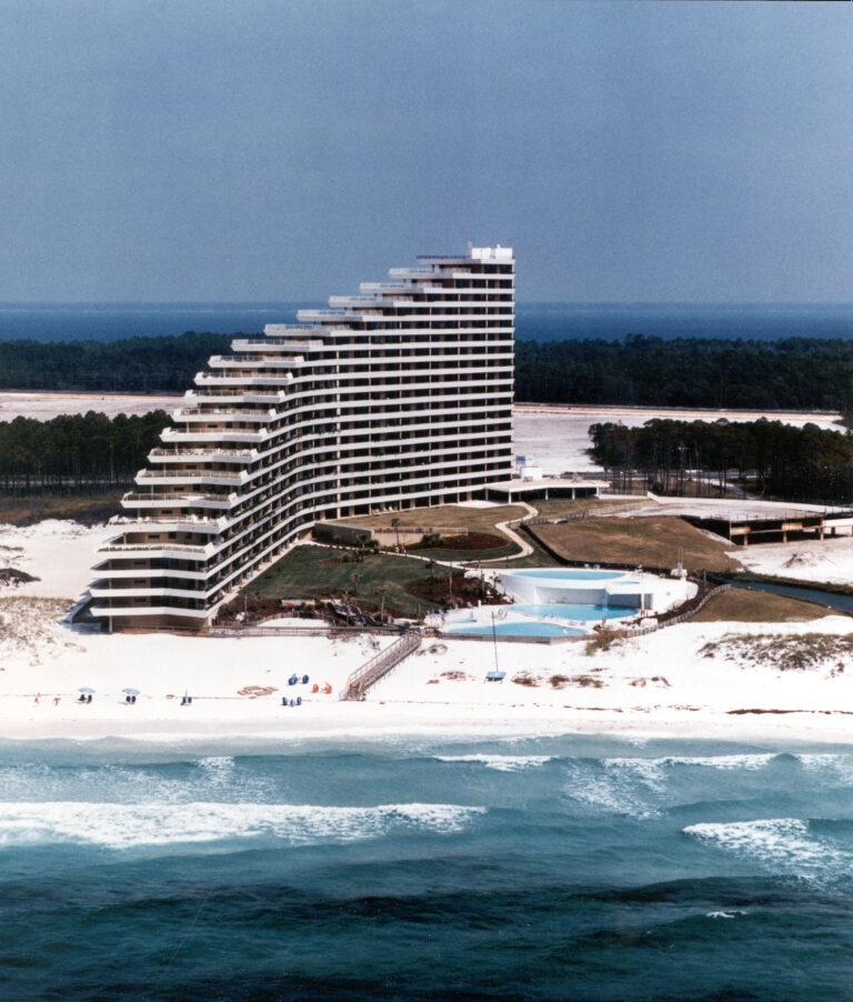 A vintage photo of a condo building on the beach.
