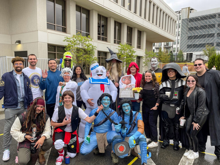 Group of people in various costumes posing together for a photo.