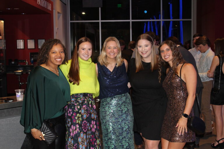 Five women posing together and smiling at a social event in Birmingham, Alabama.