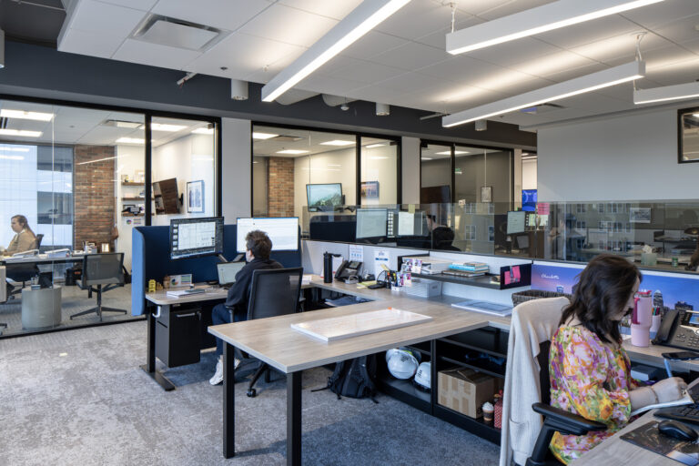 Office environment in Charlotte, NC, with employees working at their desks.