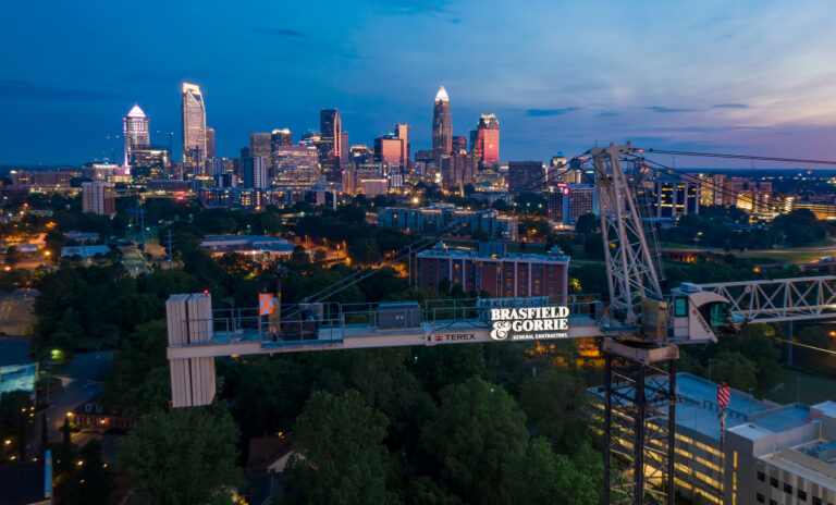 Twilight cityscape with construction crane in the foreground, Charlotte NC.