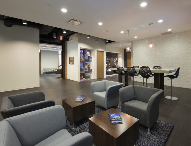 Modern office waiting area with comfortable seating and contemporary decor.