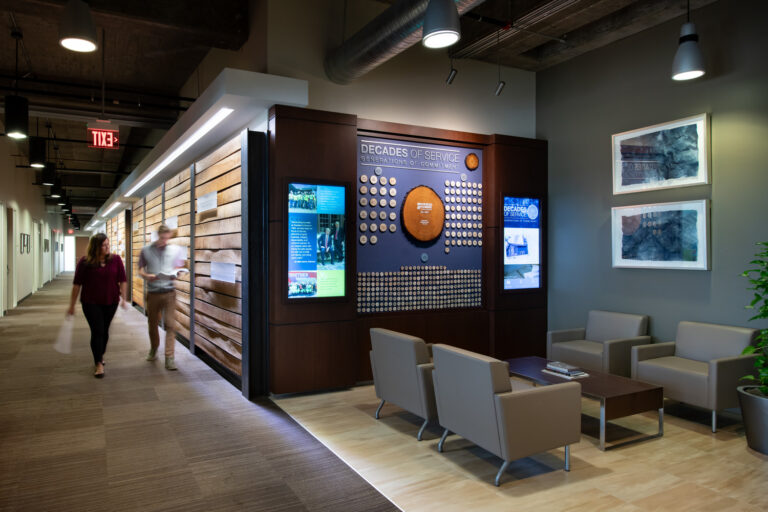 Modern office lobby in Orlando, Florida with a commemorative wall display and seating area.