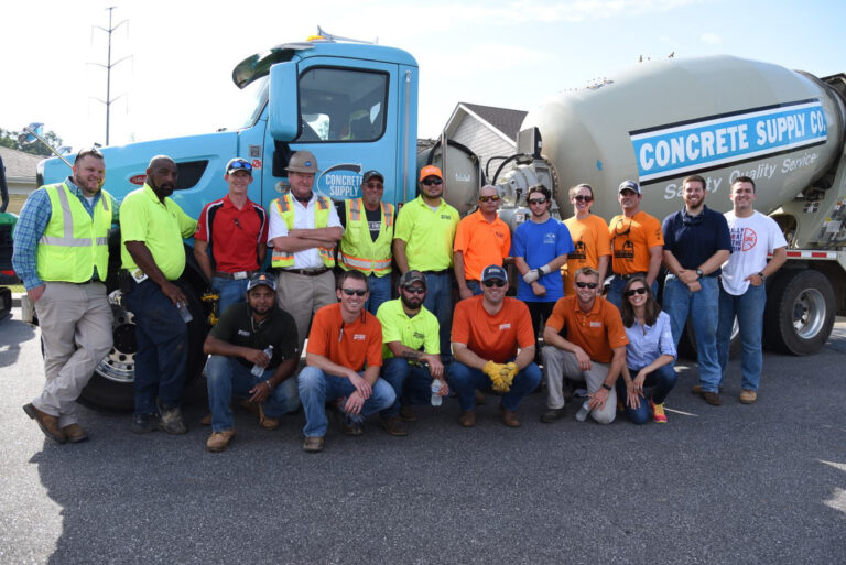 Construction team posing in front of a concrete supply truck in Greenville, South Carolina.