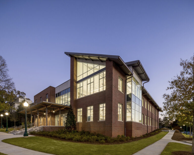 Modern educational building with large windows at dusk