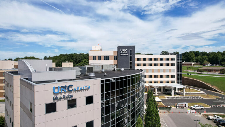 An aerial view of the UNC Health Blue Ridge facility, featuring modern architecture and multiple buildings.