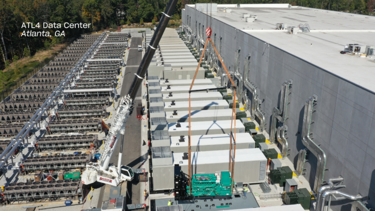 Aerial view of AT4 Data Center in Atlanta, GA, showing cranes lifting equipment onto the building.