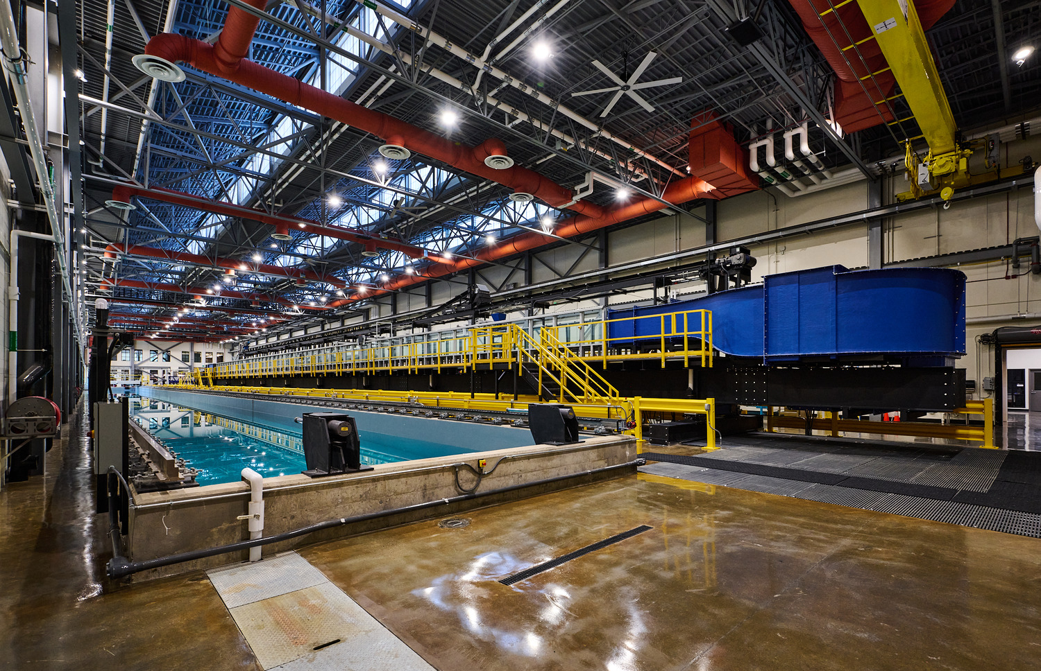 The tilting flume, a unique 250-foot-long river simulator, sits atop a 9-foot-deep concrete tank. It circulates water through a channel to study sediment interaction. This setup allows observation of how various materials behave in water, offering insights into river dynamics. The lab equipment was $11 million dollars of the contract.