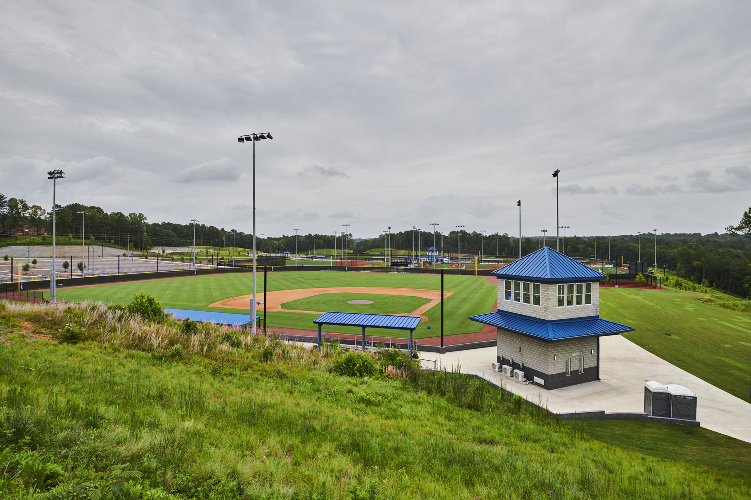 Phase II of the Hoover Metropolitan Complex outdoor facility includes five NCAA regulation-size soccer/football/lacrosse fields (can be converted to ten youth fields), five NCAA regulation-size baseball/softball fields (four with artificial turf, one with natural grass), 16 tennis courts with pro shop, a playground, a splash pad, and a large event lawn.